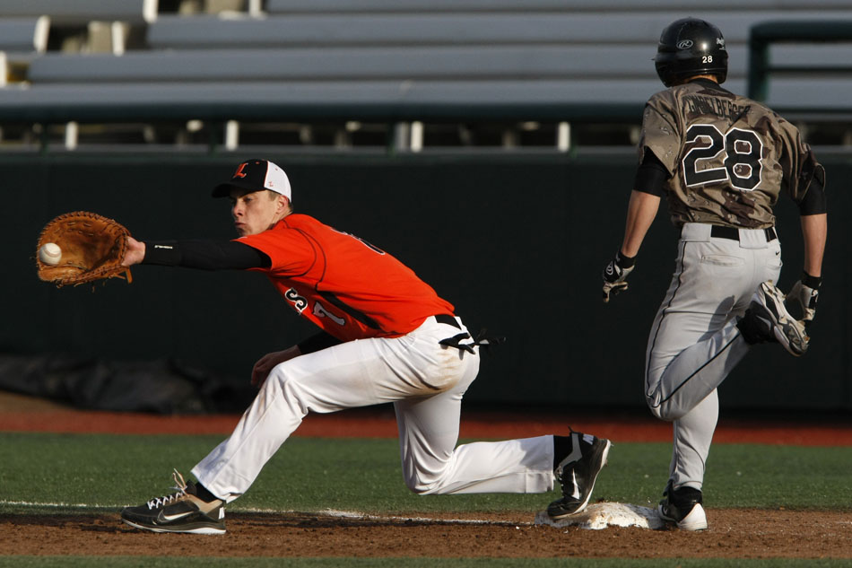 Penn's Chad Gindelberger, right, beats a throw to LaPorte's Ian Price during a high school baseball game on Thursday, March 29, 2012, at Coveleski Stadium in South Bend. (James Brosher/South Bend Tribune)