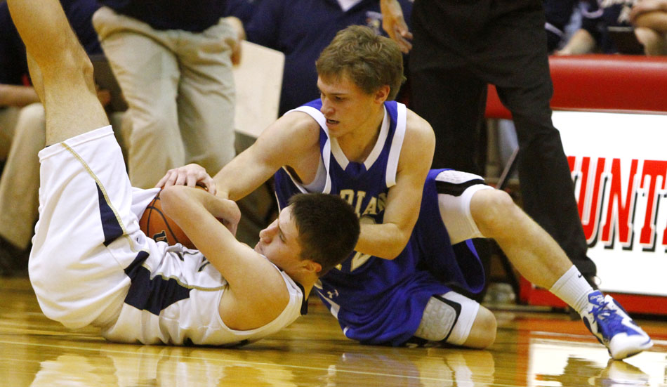 Mishawaka Marian's Michael Whitfield, right, fights for a loose ball with Norwell's Kyle Fillman during a Class 3A semistate on Saturday, March 17, 2012, at Huntington North High School in Huntington, Ind. (James Brosher/South Bend Tribune)