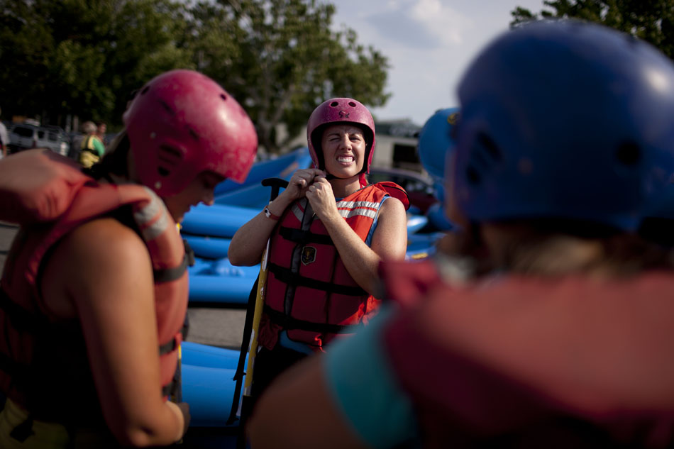 A member of the Young Professionals Network straps on her helmet on Tuesday, July 17, 2012, at the East Race Waterway in downtown South Bend. (James Brosher/South Bend Tribune)