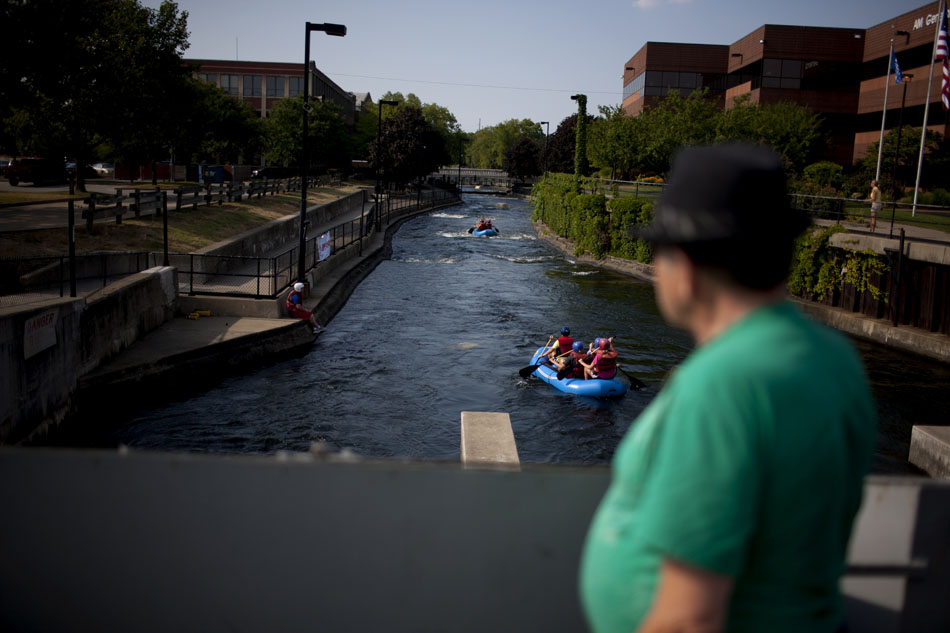 Team of rafters from the Young Professionals Network make their way down the East Race Waterway on Tuesday, July 17, 2012, in downtown South Bend. (James Brosher/South Bend Tribune)