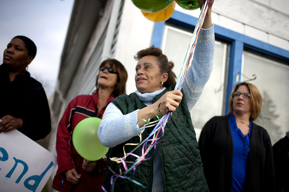 Cheryl King, center, prepares to release balloons during a memorial for Tramelle Sturgis on Saturday, Nov. 10, 2012, at the Patch Barber Shop in South Bend. (James Brosher/South Bend Tribune)