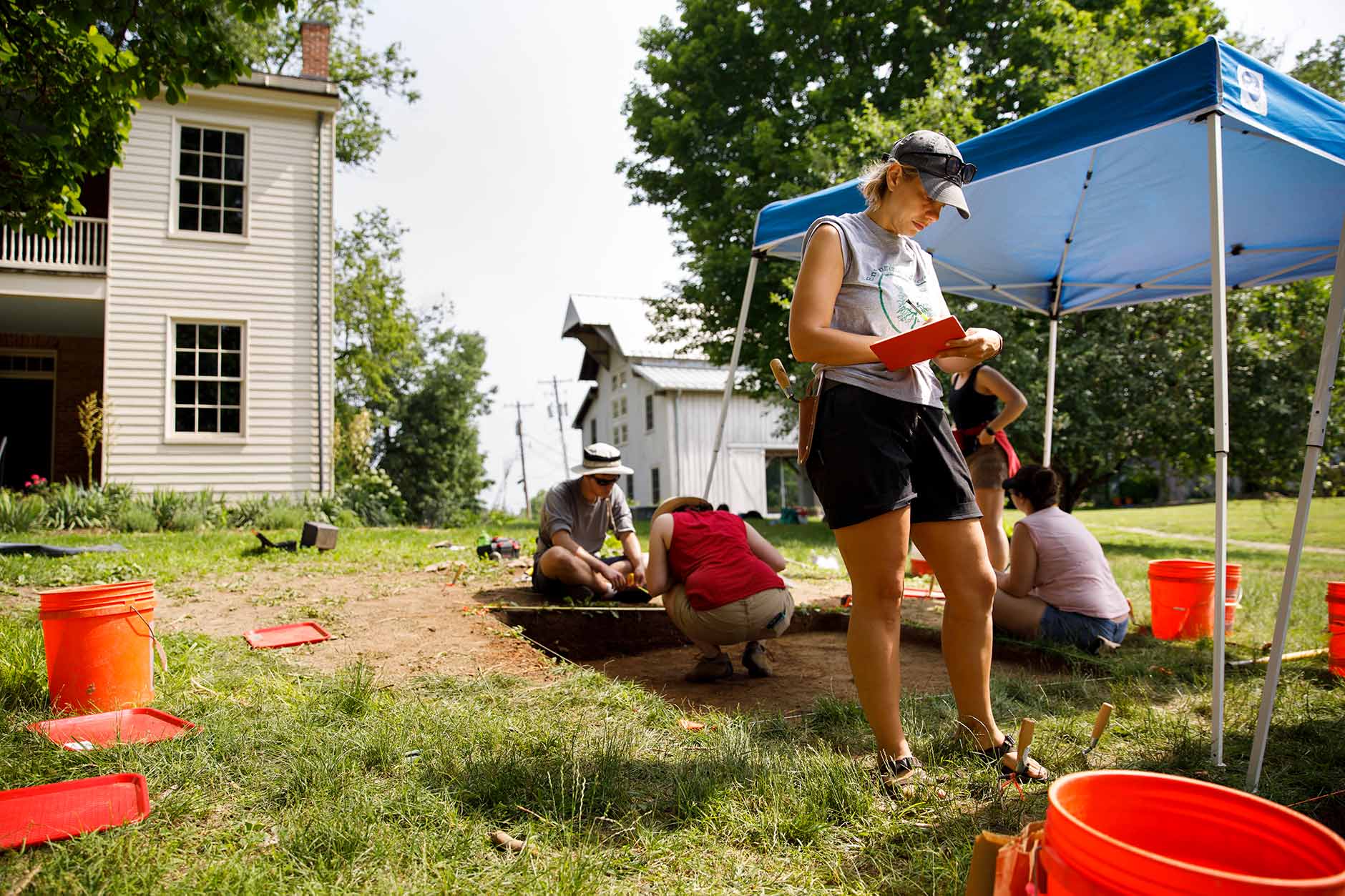 Elizabeth Watts Malouchos, a research scientist at the Indiana University Glenn A. Black Laboratory of Archaeology, takes notes during an archaeological project at Wylie House in Bloomington on Thursday, June 7, 2018. (James Brosher/IU Communications)