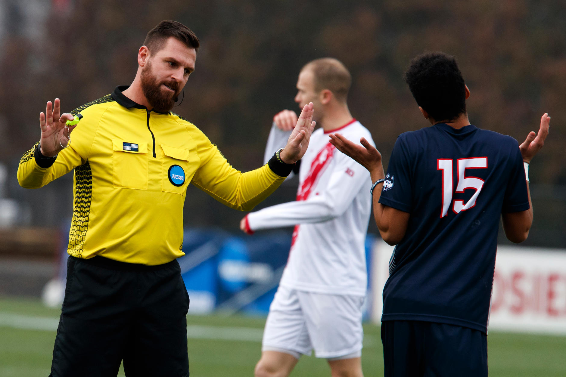 Referee Aaron Hernandez Connecticut's Cole Venner (15) during the second half of an NCAA men's soccer tournament match at Bill Armstrong Stadium in Bloomington, Ind. on Sunday, Nov. 18, 2018. IU won 4-0. (James Brosher for The Herald-Times)