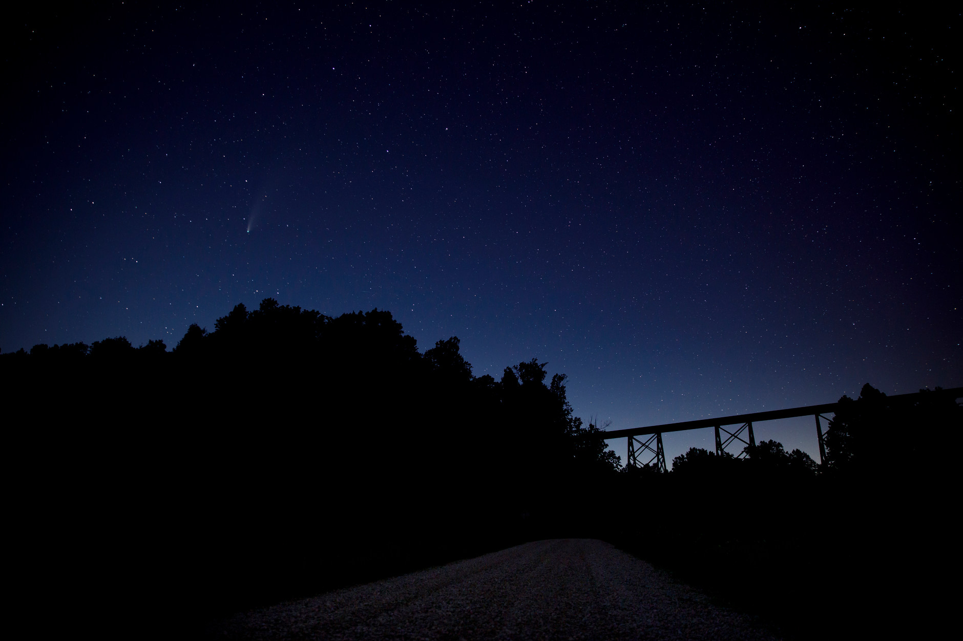 Comet NEOWISE is seen in the night sky near the Tulip Viaduct, pictured in silhouette at right, in rural Greene County, Indiana on Thursday, July 23, 2020. (Photo by James Brosher)